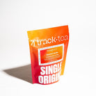 4 Track Tea Bourbon Vanilla Tea Bag packaging, a stand up pouch with an orange to red gradient photographed on a stark white background. 
