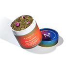 Open container of '4 track-tea' Kool Mint Herbal tea with visible tea leaves and pink flowers on a white background.