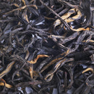 Close-up of dried black tea leaves from China, ranging in color from golden tips to black leaves