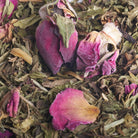 Close-up of dried pink rose petals and green leaves